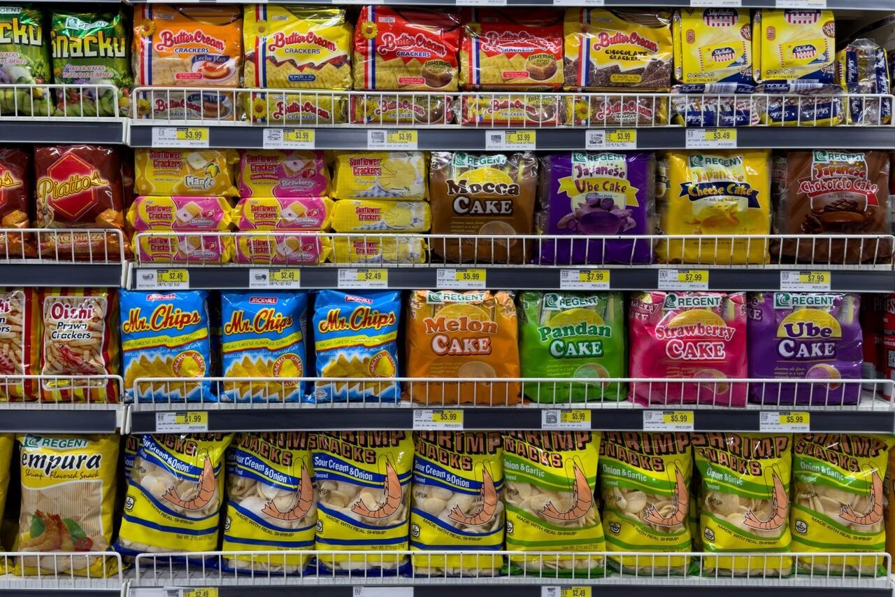 Packets of ultra-processed foods on a supermarket shelf
